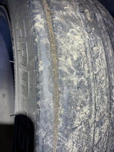 This tyre is worn and the cords are showing, it is not legal.